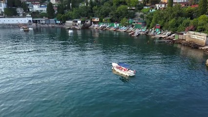 Poster - aerial flying shot of fast motor boat near the sea coast bay