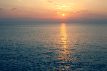  Sunset Sea over the Horizont. Beautiful Ocean Sunshine Landscape, Shimmering Twilight with yellow colors, Warm marine dusk Sun, Reflecting sunlight over the water