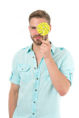 Check your vision. Man holds big lollipop in front of eye. Guy concentrated face passing vision test isolated white. Man visiting ophthalmology room. You should visit ophthalmologist to check vision