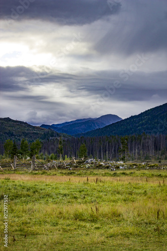 Fényképezés Peaks of the Rocky Mountains Jut out into a Stormy Sky with a Meadow in the Fore