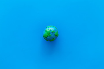 planet, ecology. plastiline symbol of planet earth globe on blue background top view copy space