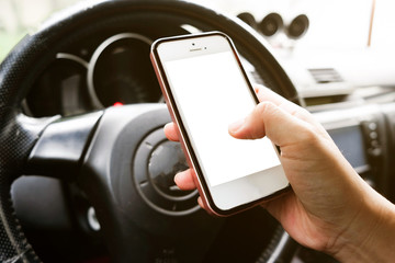 Closeup of hand holding smart phone in a car.