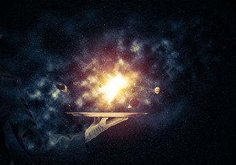 hand of waitress presenting solar system on tray.