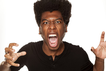 Wall Mural - Portrait of young aggressive african american man  on white background