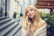 © Bojan - Portrait of beautiful young blonde woman talking on mobile phone on the city street.