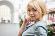 © Bojan - Closeup portrait of young beautiful blonde hair woman looking at camera outdoors