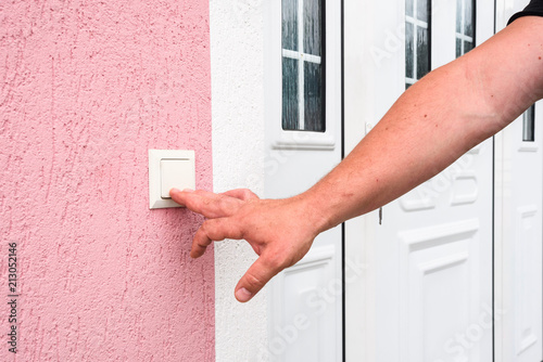 Obraz na plátně hand ringing on doorbell on pvc front door