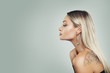 © artmim - Luxurious Woman with Healthy Blonde Hairstyle, Makeup and Black Pearls Earrings on Background with Copy space, Profile
