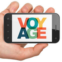 Wall Mural - Travel concept: Hand Holding Smartphone with Painted multicolor text Voyage on display, 3D rendering