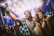 © NDABCREATIVITY - Happy friends taking selfie at music festival