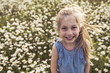 © Louis-Paul Photo - child on green daisy grass in a summer park sunset time