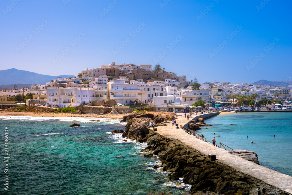 Chora of Naxos island as seen from the famous landmark the Portara with the natural stone walkway towards the village, Cyclades, Greece. - obrazy, fototapety, plakaty 