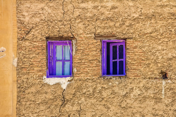 Bright purple windows on an ancient facade in the Fes medina