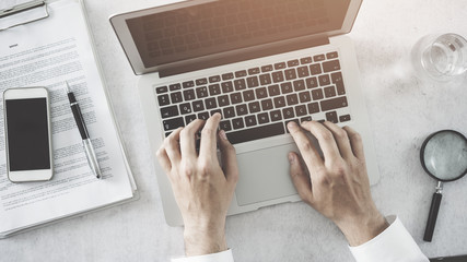 Male hands using laptop computer