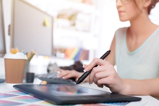 Artist drawing something on graphic tablet