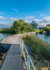 Wall Mural - The charming village of Busskirch (Kirchdorf), Rapperswil-Jona, Sankt Gallen, Switzerland. Located in an idyllic lakeside shore of the Obersee (Upper Lake Zurich) .