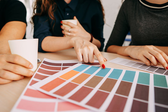 Professional team of designers and colorists working with color palettes in studio, close up. Design, innovations, creative work and new projects. Digital art, developing, media concept