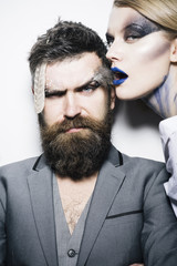 Wall Mural - Visage course. Sensual woman and bearded man with creative makeup, visage course. Visage course of professional makeup. Visage course in beauty salon. Find your best look here