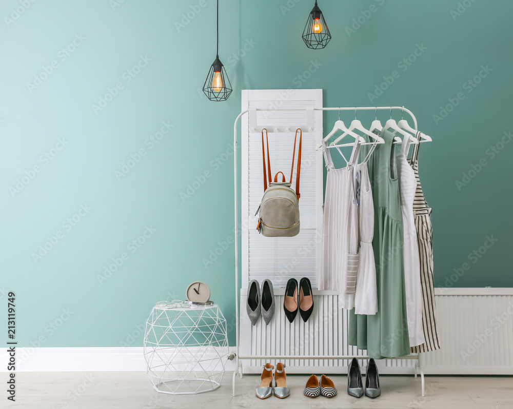 Stylish dressing room interior with clothes on rack Stock Photo | Adobe ...