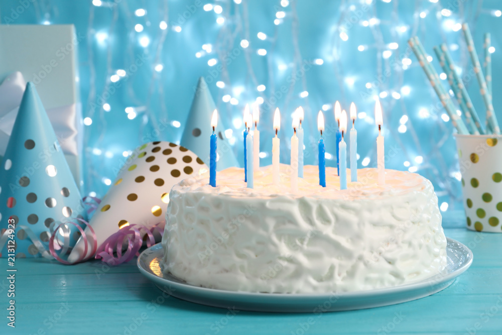 Delicious birthday cake with burning candles on table Stock Photo ...