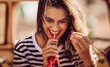 Beautiful young woman drinking soda