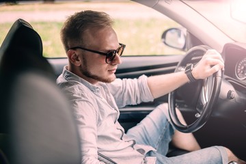 Wall Mural - young male business car driver.