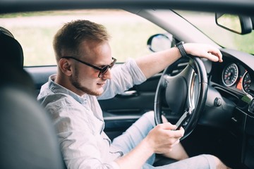 Wall Mural - young male business car driver.