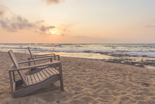 Empty Beach Chairs On The Coast At Sunset