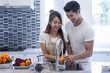 © stockphotokae - Beautiful asian young couple loving smiling is looking to cooking in kitchen at home,Happy handsome man washing vegetables in the sink.