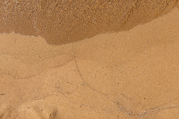 Overhead shot of sand with waves lines