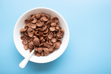 Bowl Of Cereal Chocolate Flavor And Milk Breakfast With Silver Spoon