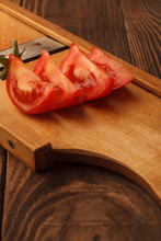 Fresh Tomato Halves On The Wooden Table