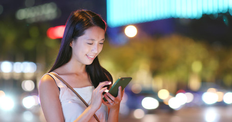 Canvas Print - Asian Woman use of app on mobile phone in city at night