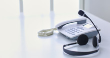 Communication Support, Call Center And Customer Service Help Desk. VOIP Headset On Laptop Computer Keyboard