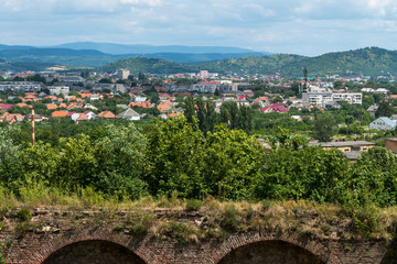 A beautiful landscape on a city lying in a mountain valley with roofs of high-rise buildings and a private sector