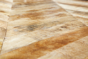 Vintage wooden parquet background. Top view of wooden texture. Herringbone, chevron flooring pattern. 