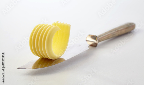 Cuadros en Lienzo Stylish curl of chilled butter on a butter knife