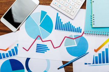 Poster - Top view of business paper chart or graph on wooden table