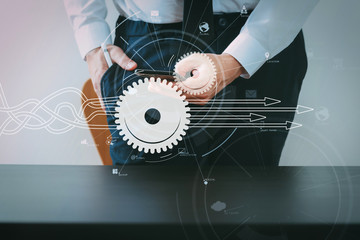 Poster - close up of businessman working with smart phone on wooden desk in modern office with virtual icon diagram