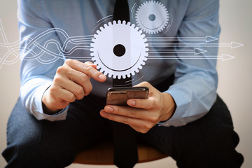 Poster - close up of businessman working with mobile phone and sitting on the chair in modern office