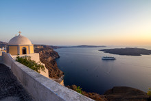Elevated Romantic Sunset Scene On Santorini. Fira, Greece, From Above. Amazing Golden Hour View From Public Path Walk Towards Volcano In The Caldera. Shortly Before The Sunset, Church In The Image