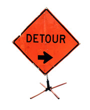 Battered DETOUR Sign With Arrow On Construction Tripod. Isolated.