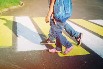 little boy and girl holding hands go to school