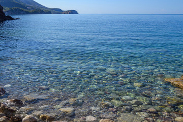 Wall Mural - The sea view. Calm sea and large stones. Transparent water of the Adriatic Sea. Montenegro