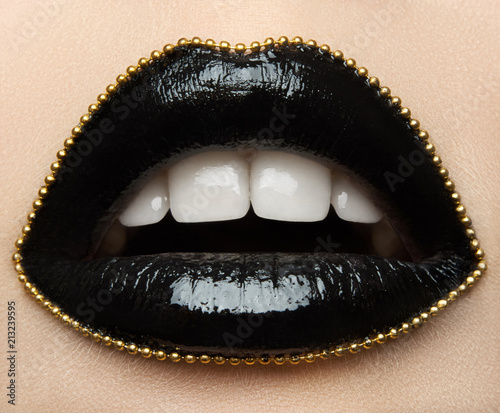 Fotografering Macro and close-up creative make-up theme: beautiful female lips with black lips