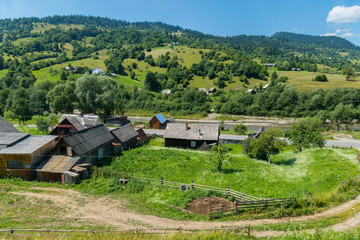 Wall Mural - panorama to the village in the Carpathians against the backdrop of the hills