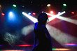© nagaets - Silhouette of dancing girl against disco lights