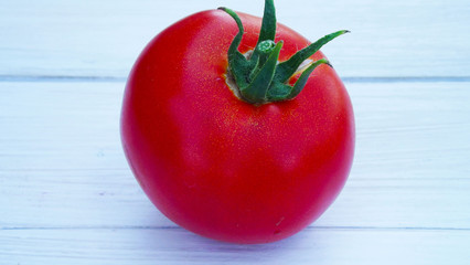 Ripe red tomatoes on a wooden background.