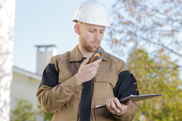 foreman on site using walkie talkie