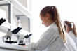 © Syda Productions - education, science and children concept - girl studying chemistry at school laboratory and writing